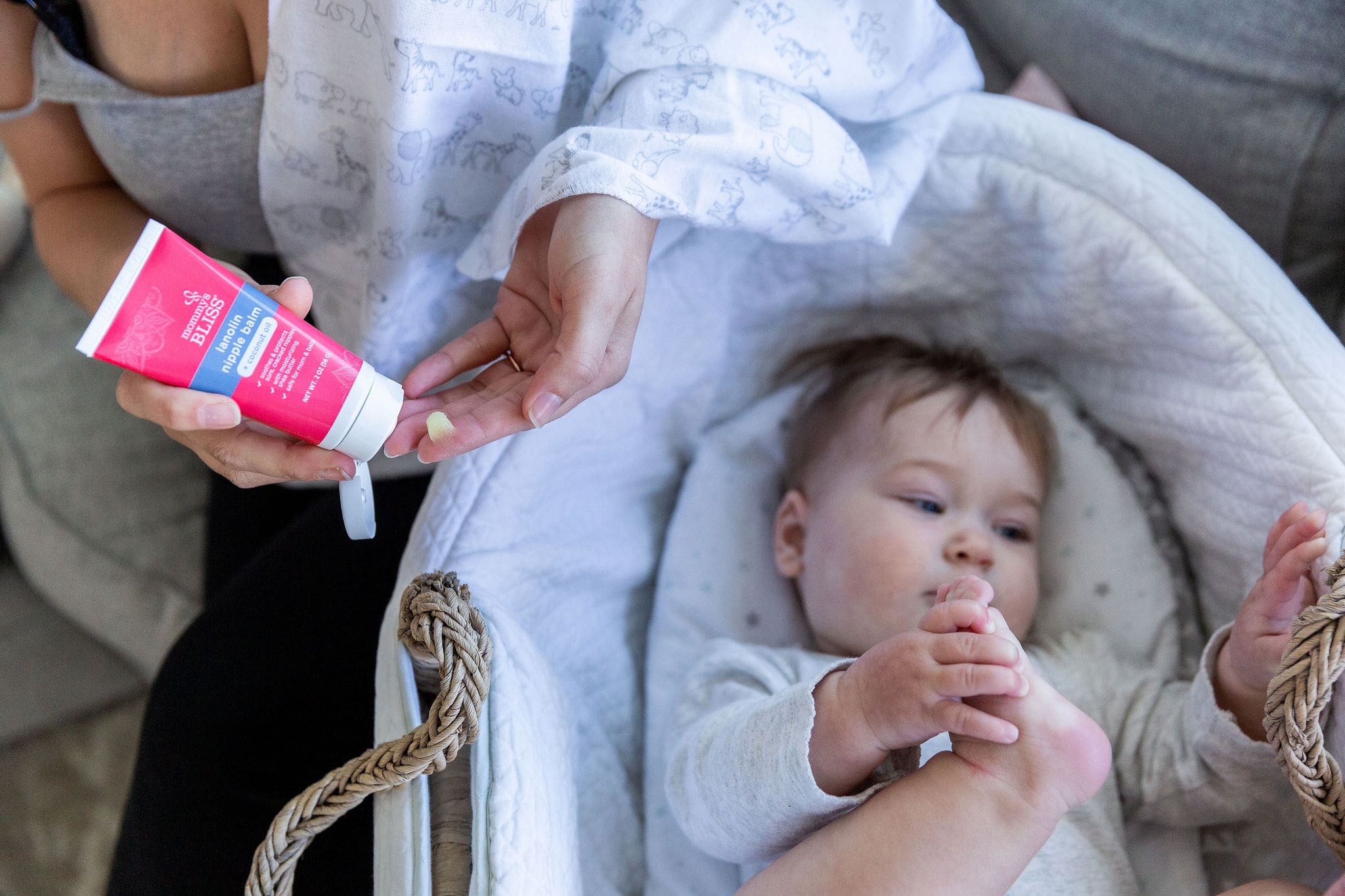 A baby and her mom using a Lanolin Nipple Balm