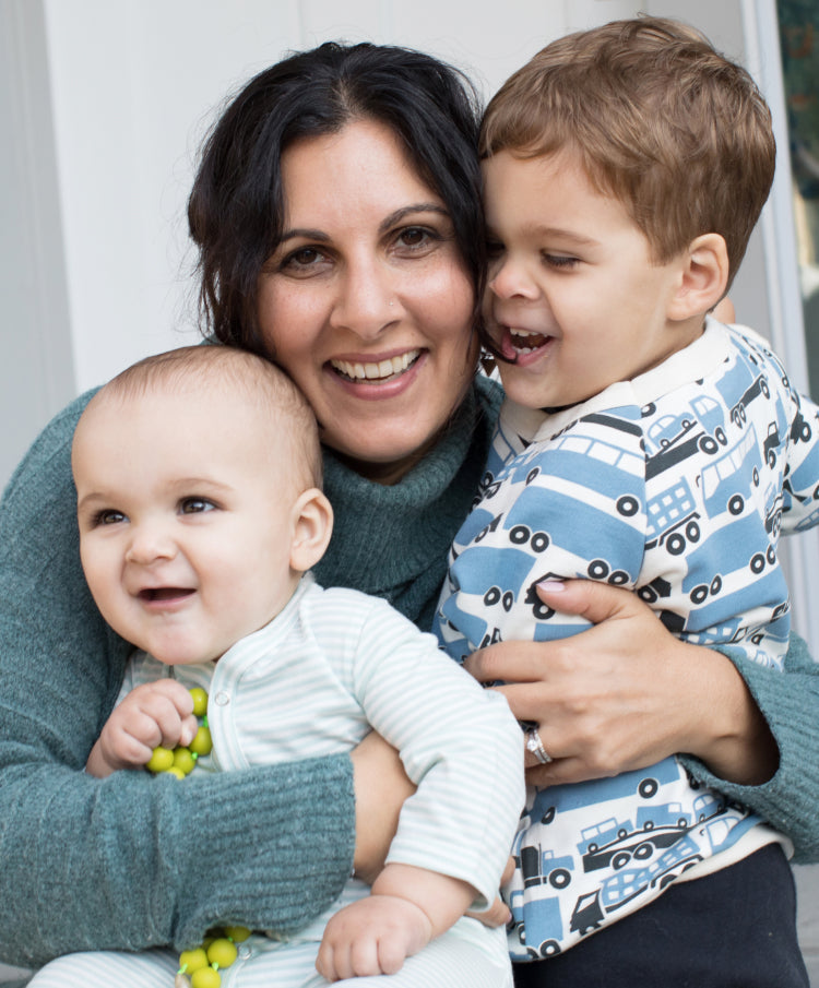A mom holding her 2 sons