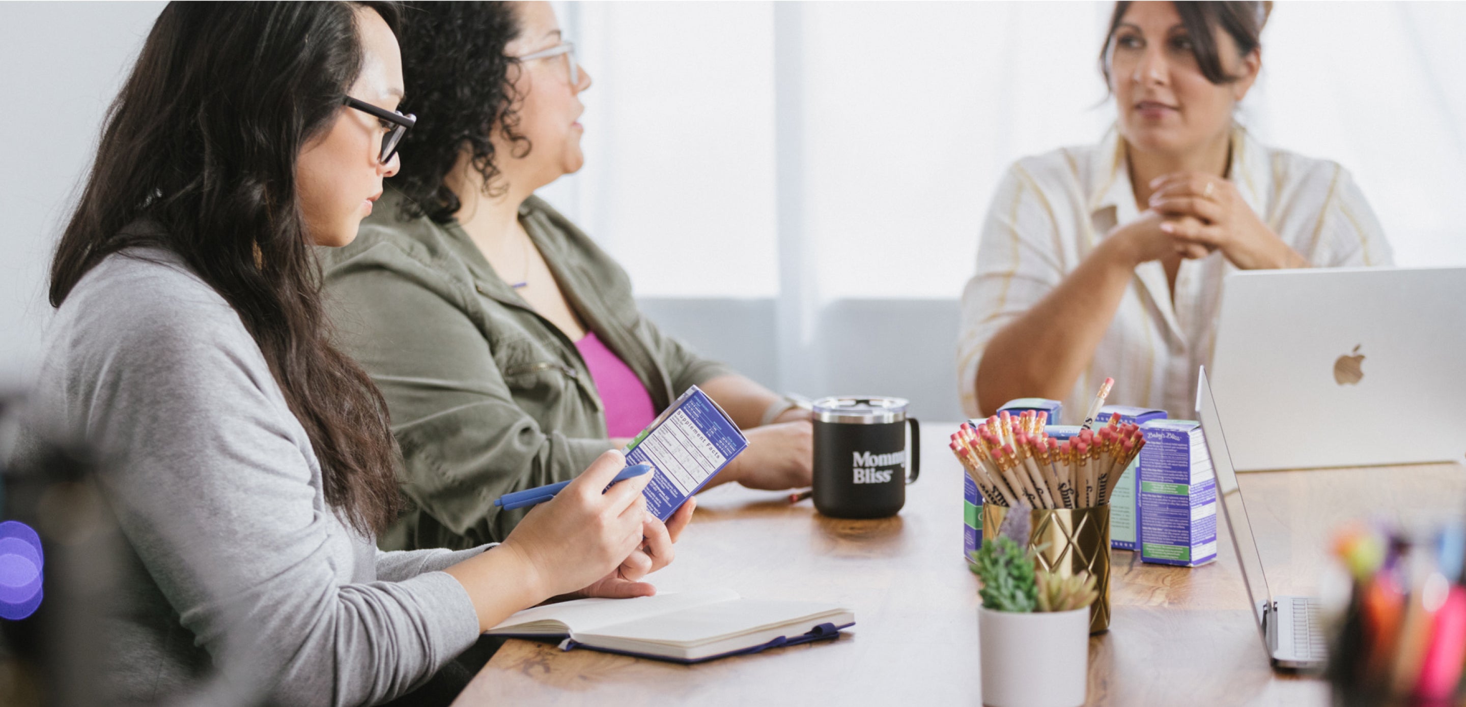 Three women having a meeting with their laptops and cellphones
