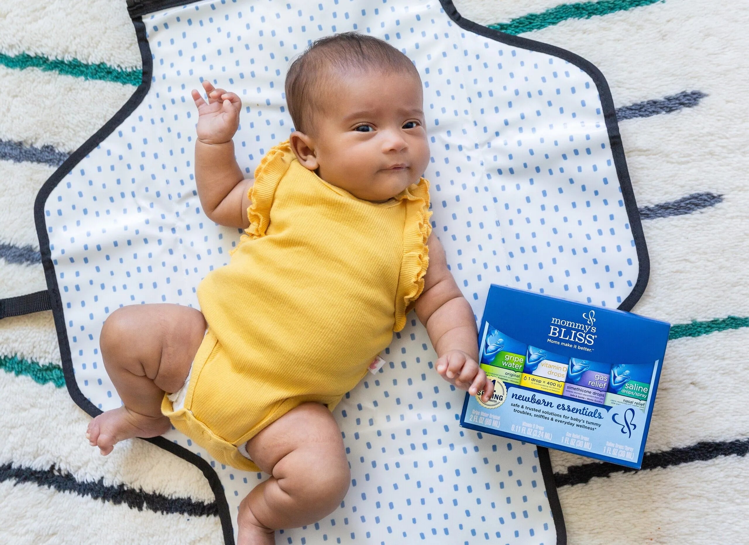 A baby and a gift basket of MB products beside her