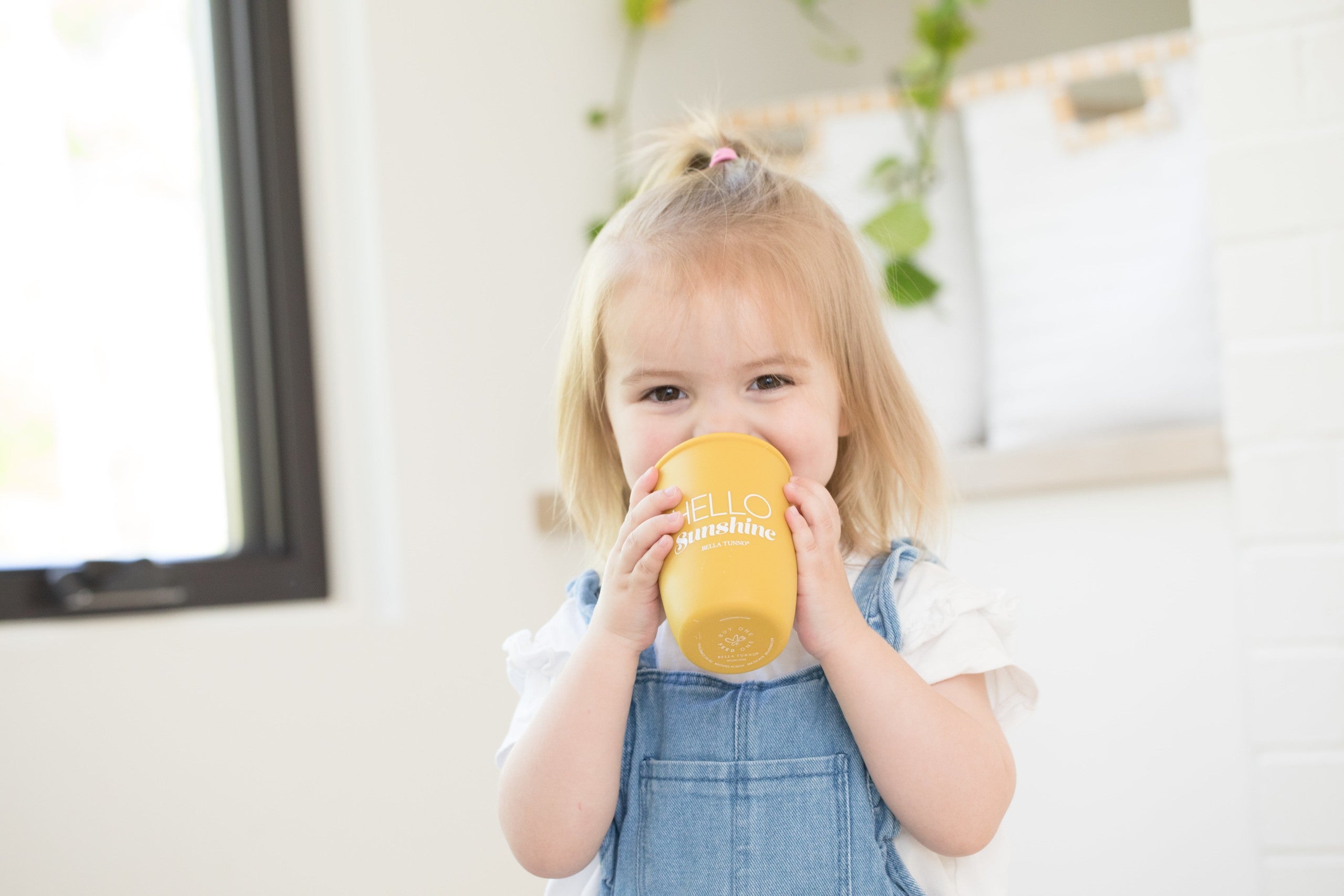 Hello Sunshine Happy Sippy Cup by Bella Tunno being used by a happy kid