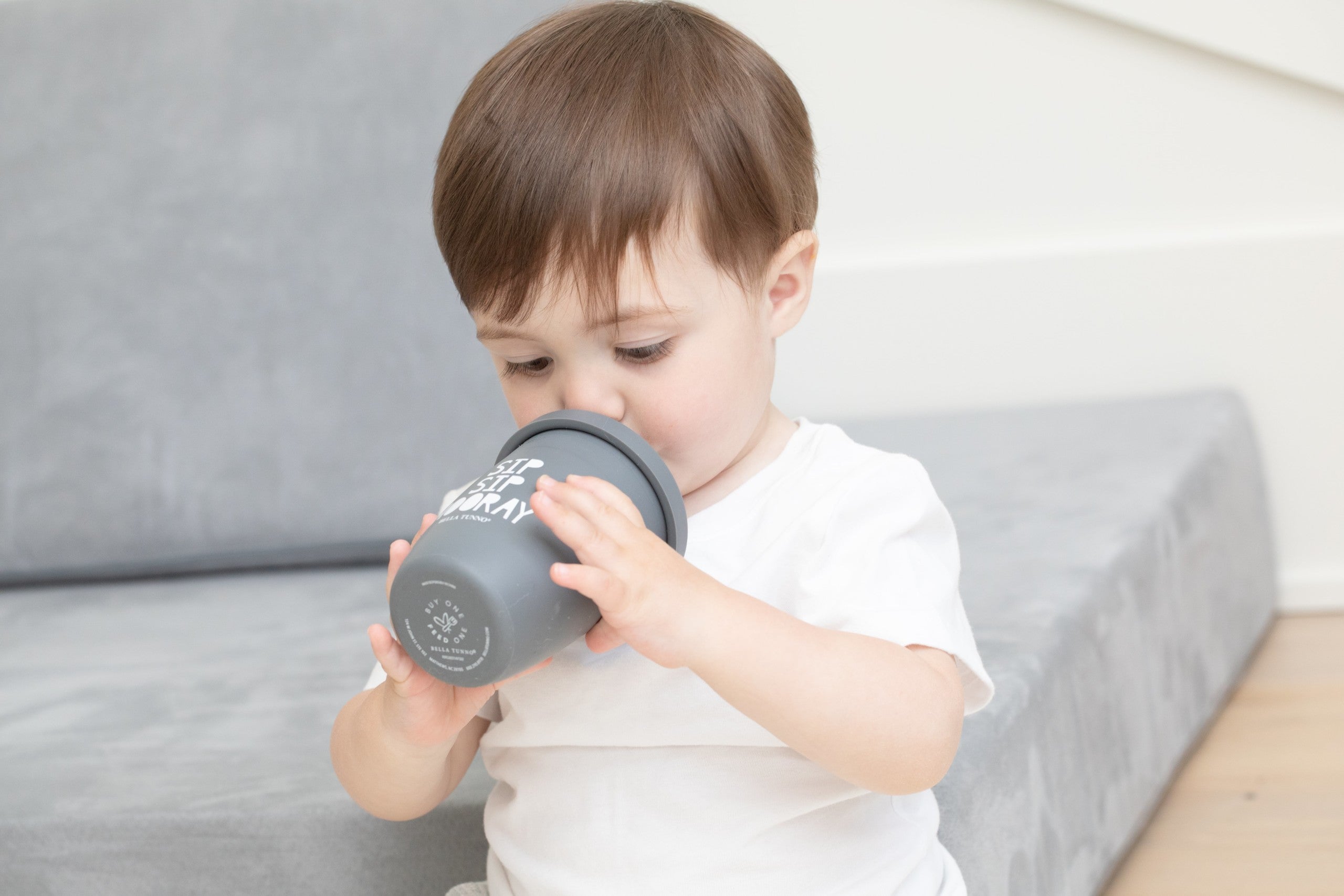 Sip Sip Hooray Happy Sippy Cup by Bella Tunno being used by a boy kid 